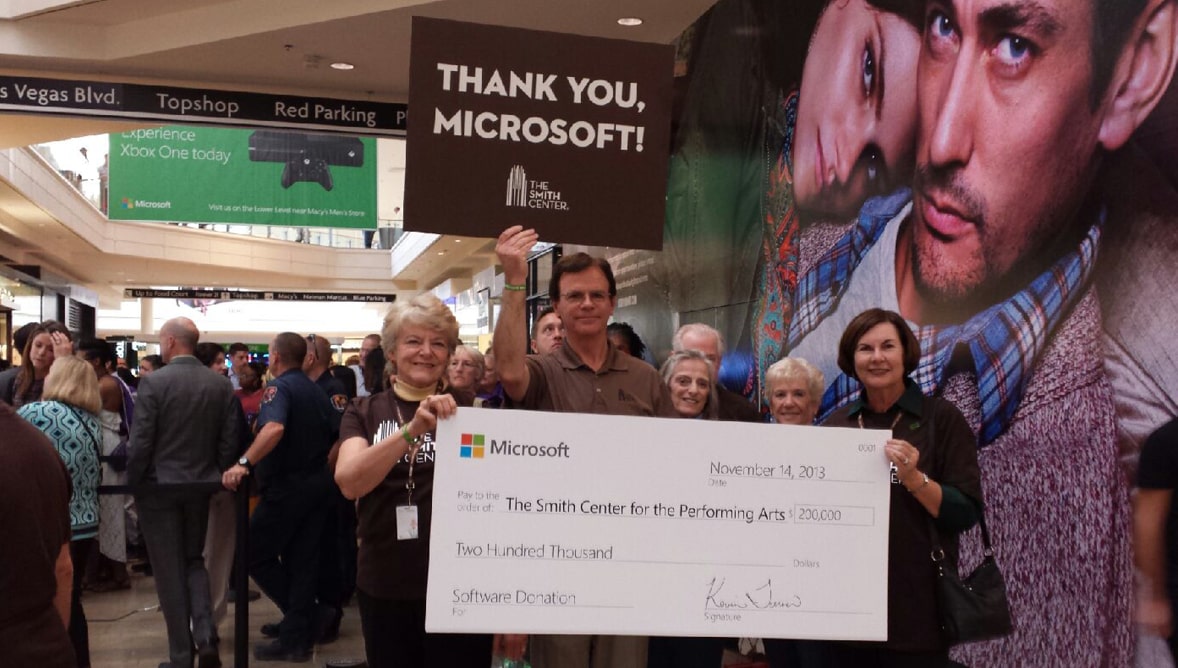 Smith Center team members holding a large check from an annual sponsor