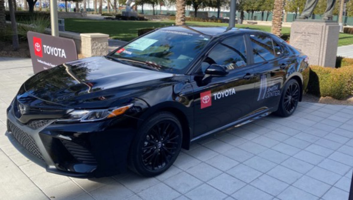 A picture of a car with sponsor logos on it in front of The Smith Center