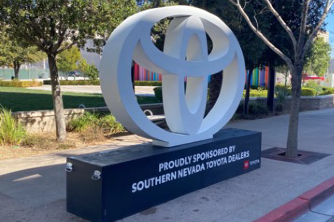 A photo of a sponsor logo sculpture in front of The Smith Center