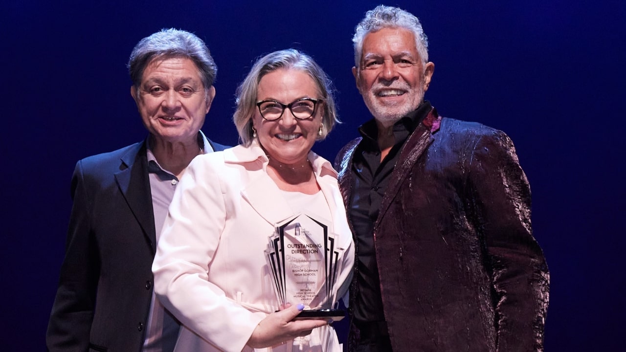 Bishop Gorman's Elena Ferrante-Martin (center) poses with Nevada High School Musical Theater Awards hosts Keith Thompson (left) and Clint Holmes after receiving the 2024 Award for Best Direction