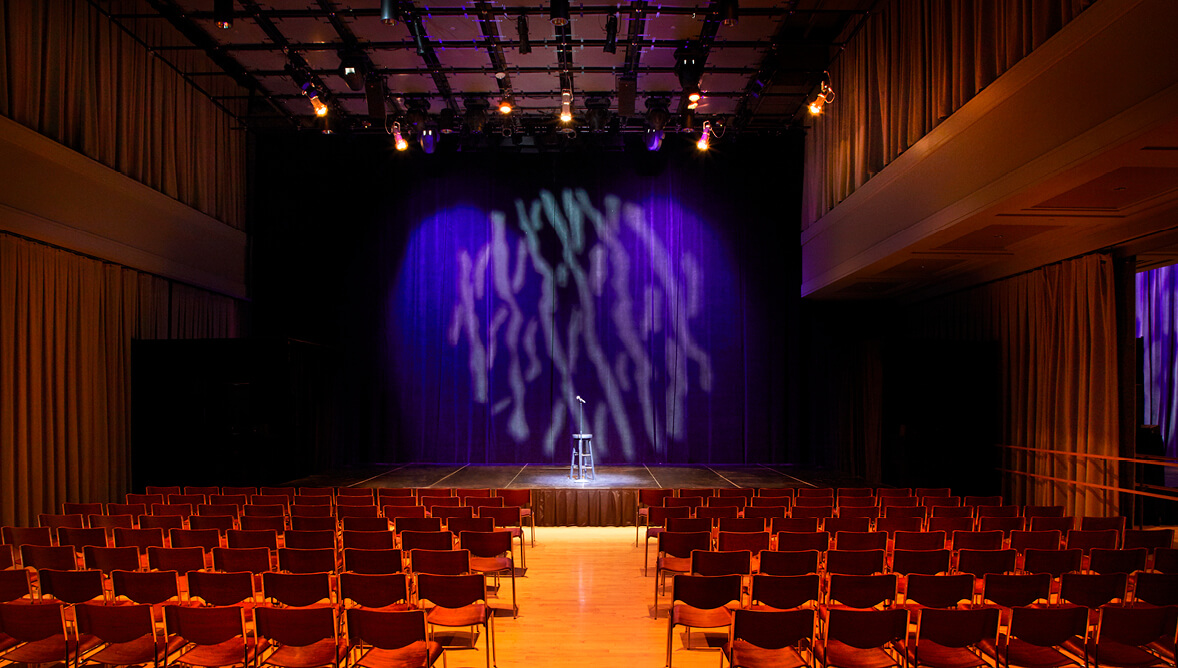 Troesh Studio Theater with chairs and a microphone
