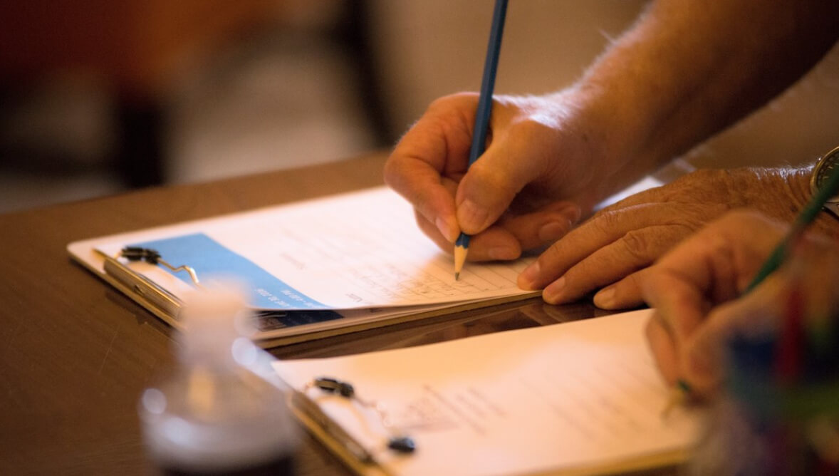 A photo of a person filling out a form.